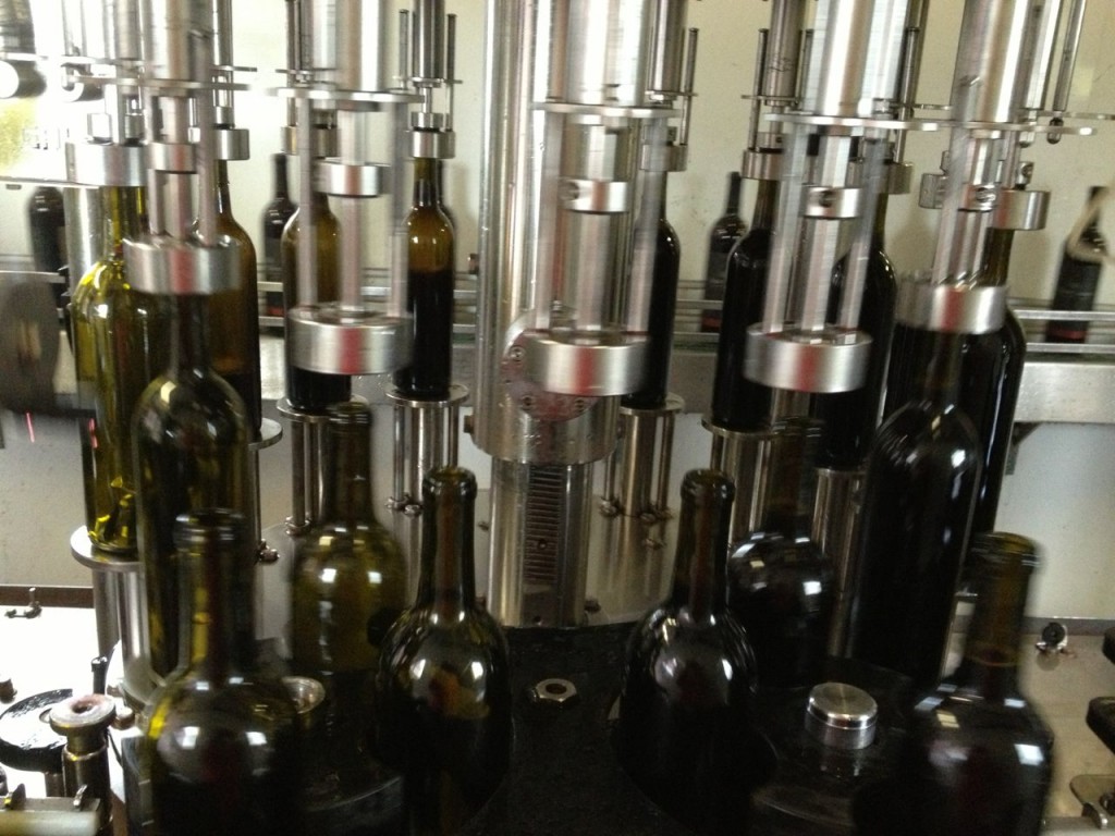 Bottles being filled with wine
