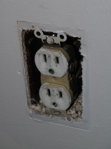 Outlet after cover that was painted while on wall was removed