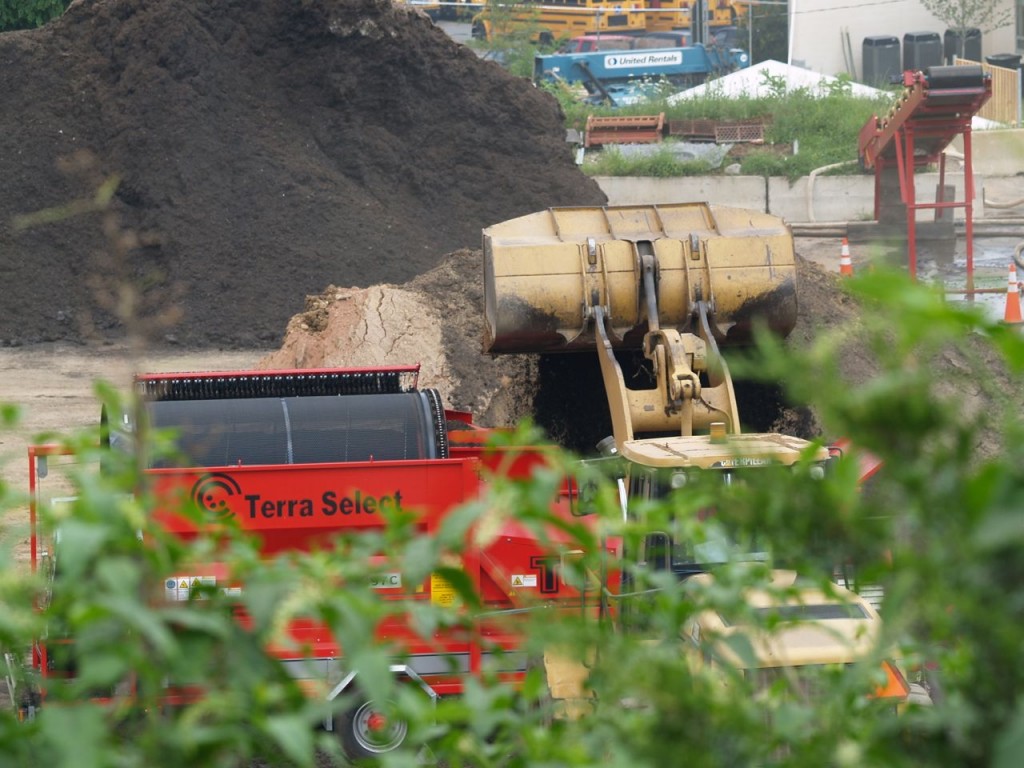 Material going into trommel screen for separation. The trommel screen sorts dirt and big aggregate.