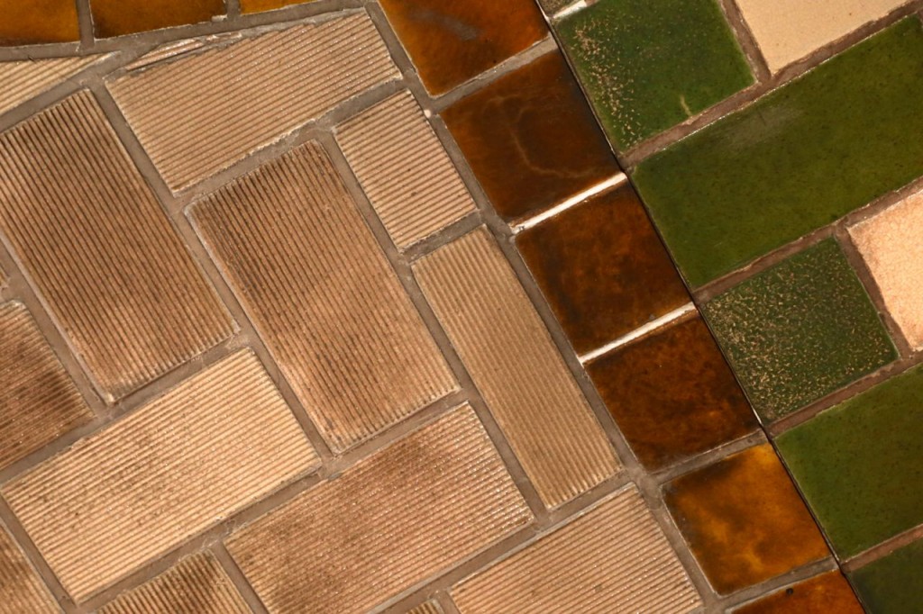 Tile on mezzanine wall. Ridges on unglazed white tile can be seen.