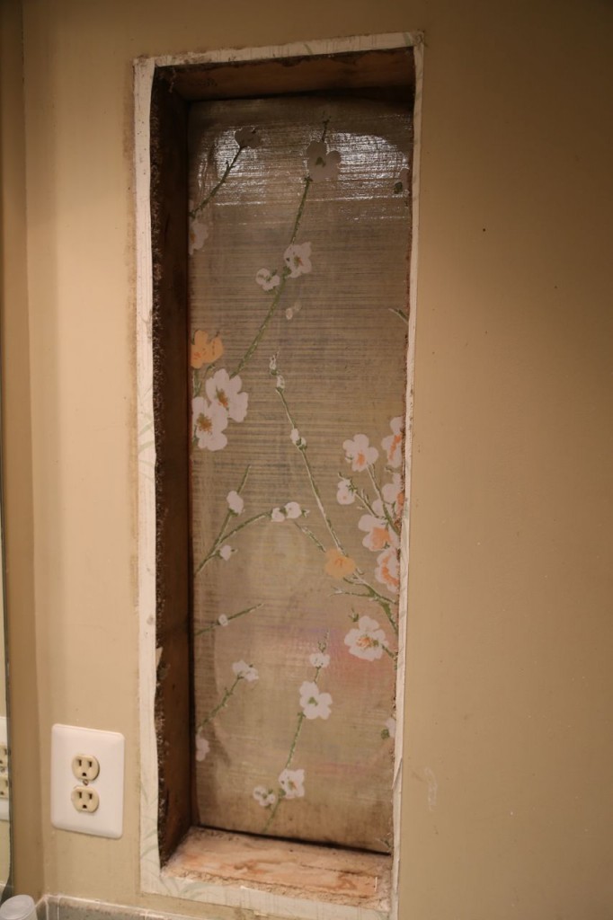 Once the medicine cabinet was removed, lovely, shiny, 1970's floral wallpaper was revealed. Why it was behind the medicine cabinet, I have no idea.