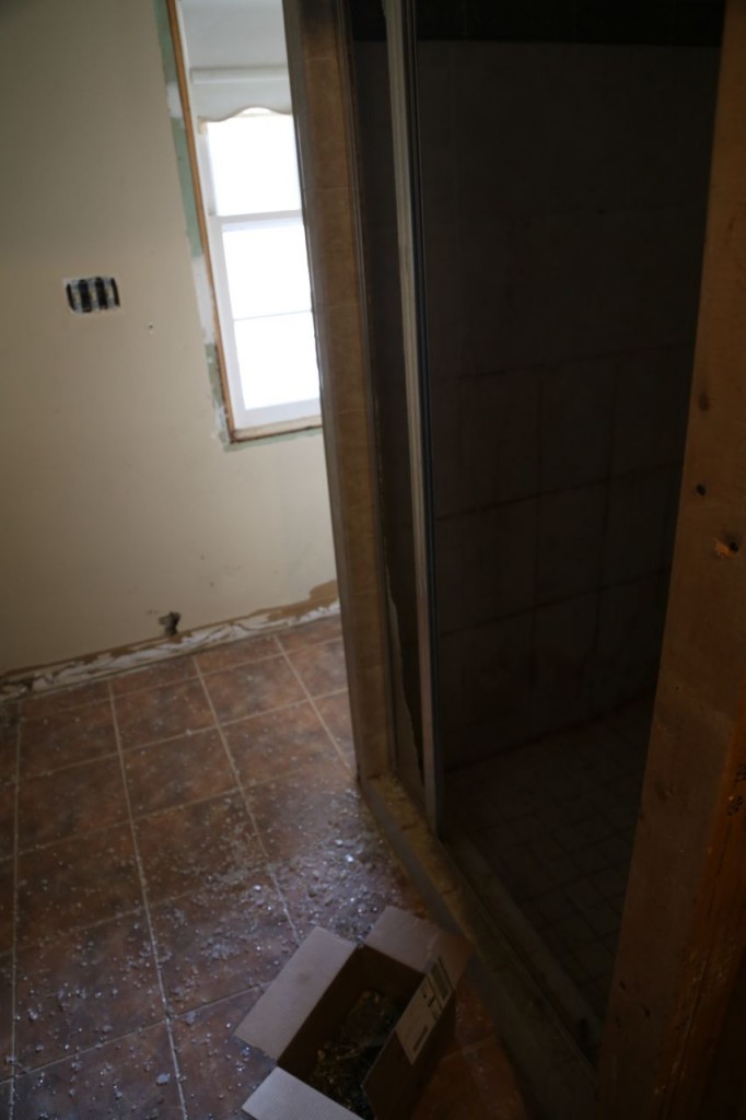 Removing the old shower glass door and wall