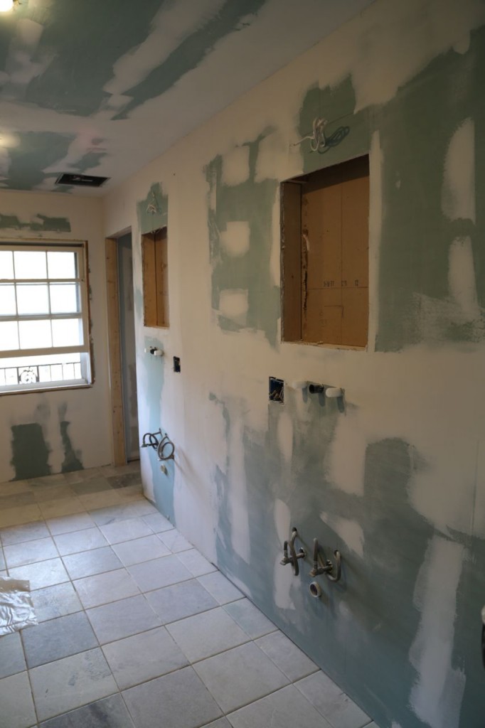 Drywall in place with holes for medicine cabinets'