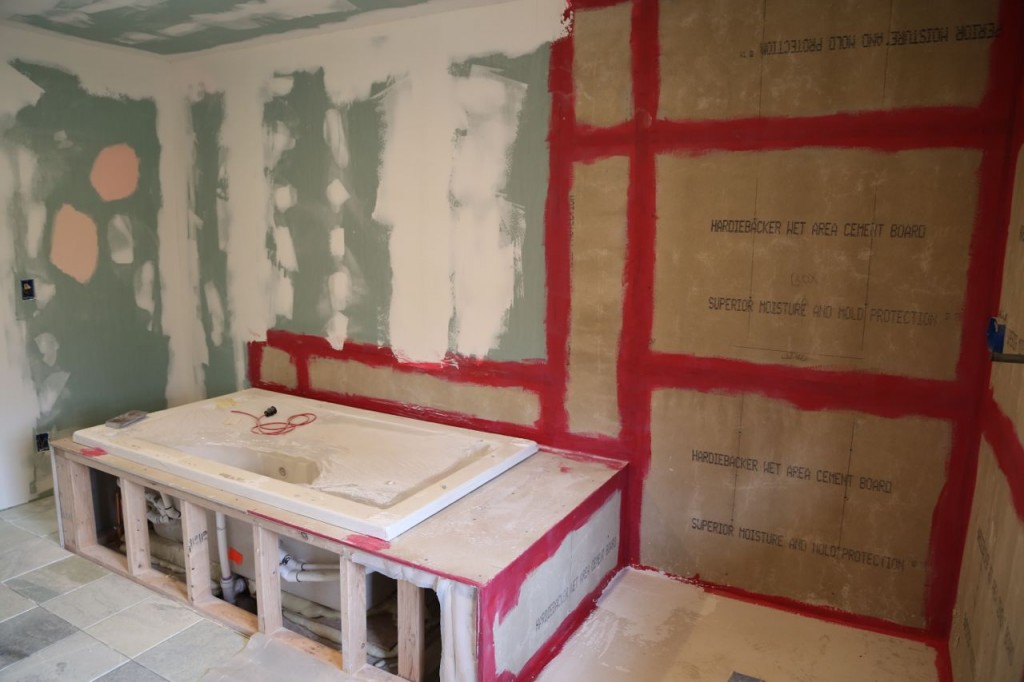 Drywall on walls and Hardiboard in shower