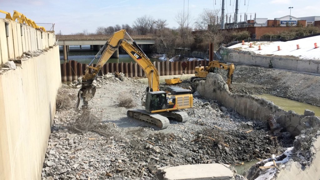 Excavator with concrete crusher twirling rebar