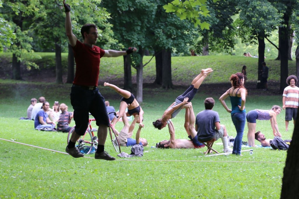 Tightrope walker with yoga gymnasts in background