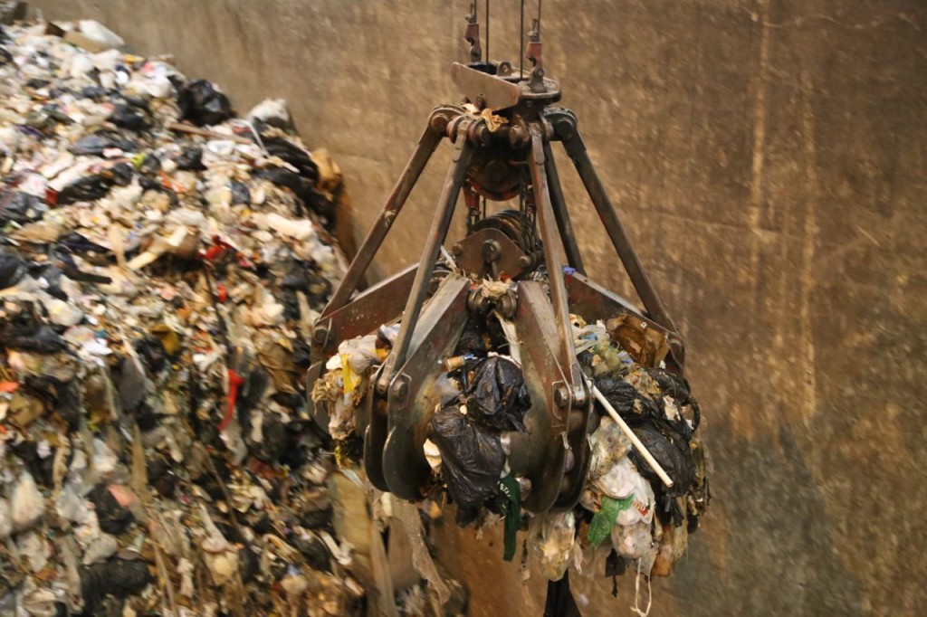 Large claw picks up trash to put into feed