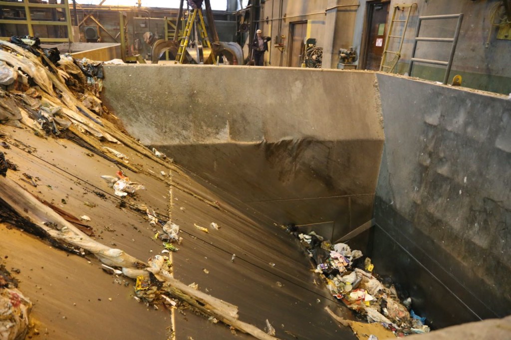 Trash slides into the entrance to the boiler