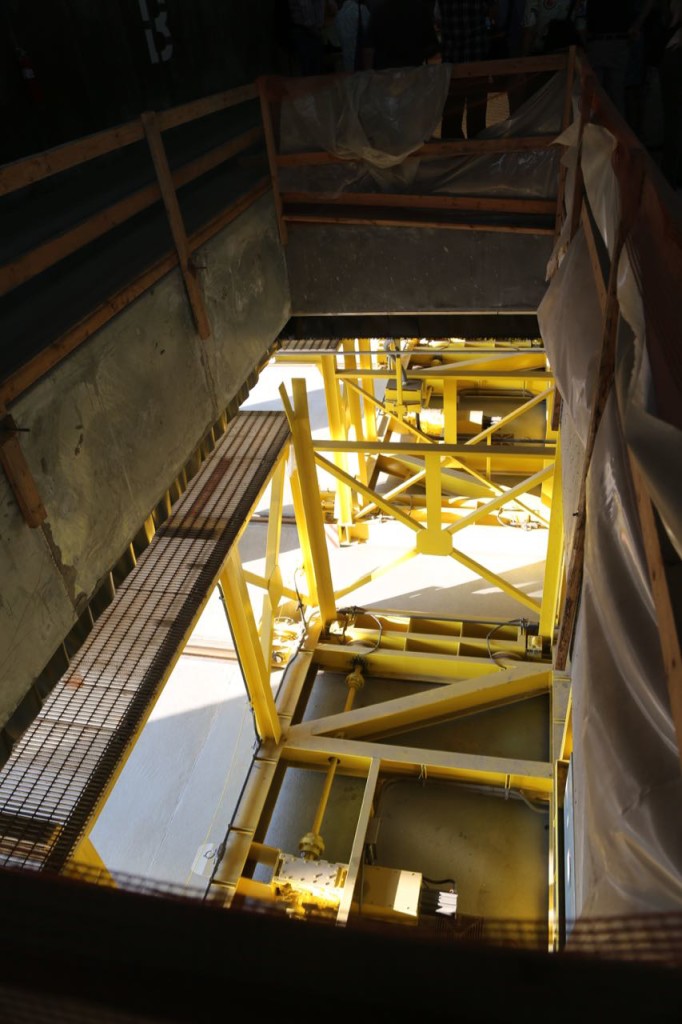 Looking down from waste mixing floor into hole where waste will be pushed into a waiting container