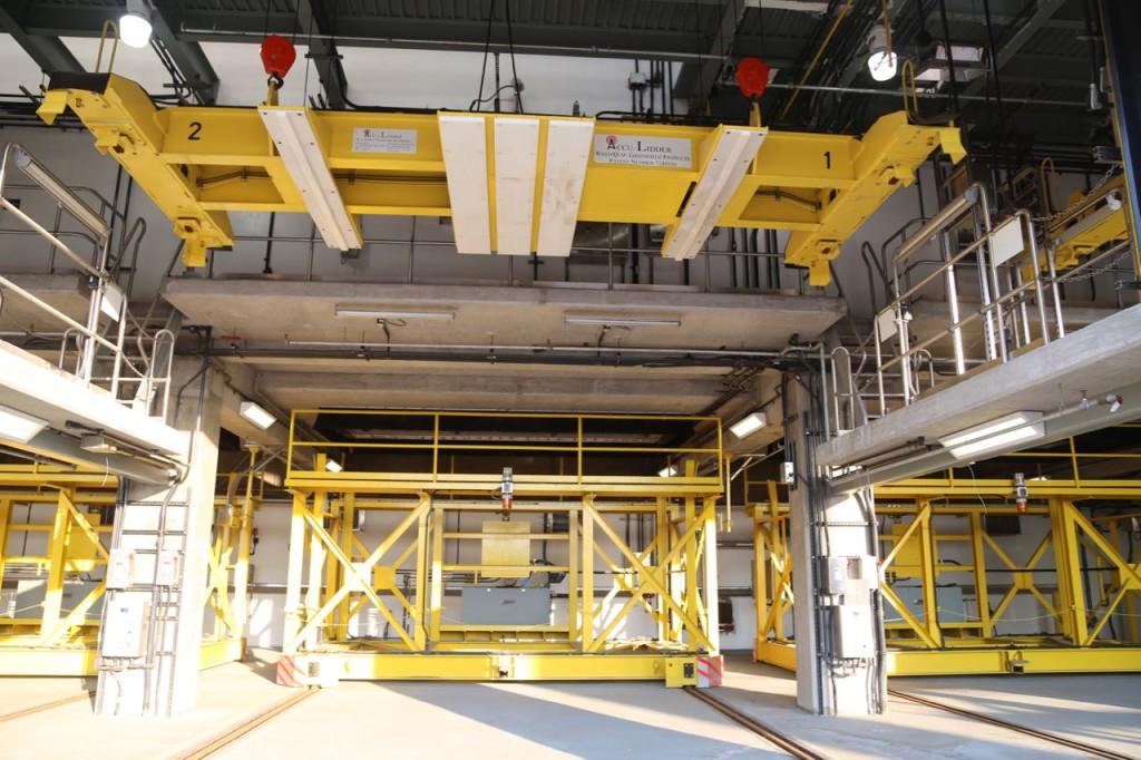 Loading bay, in foreground are toppers and behind, with yellow frames, are where containers will sit to receive waste