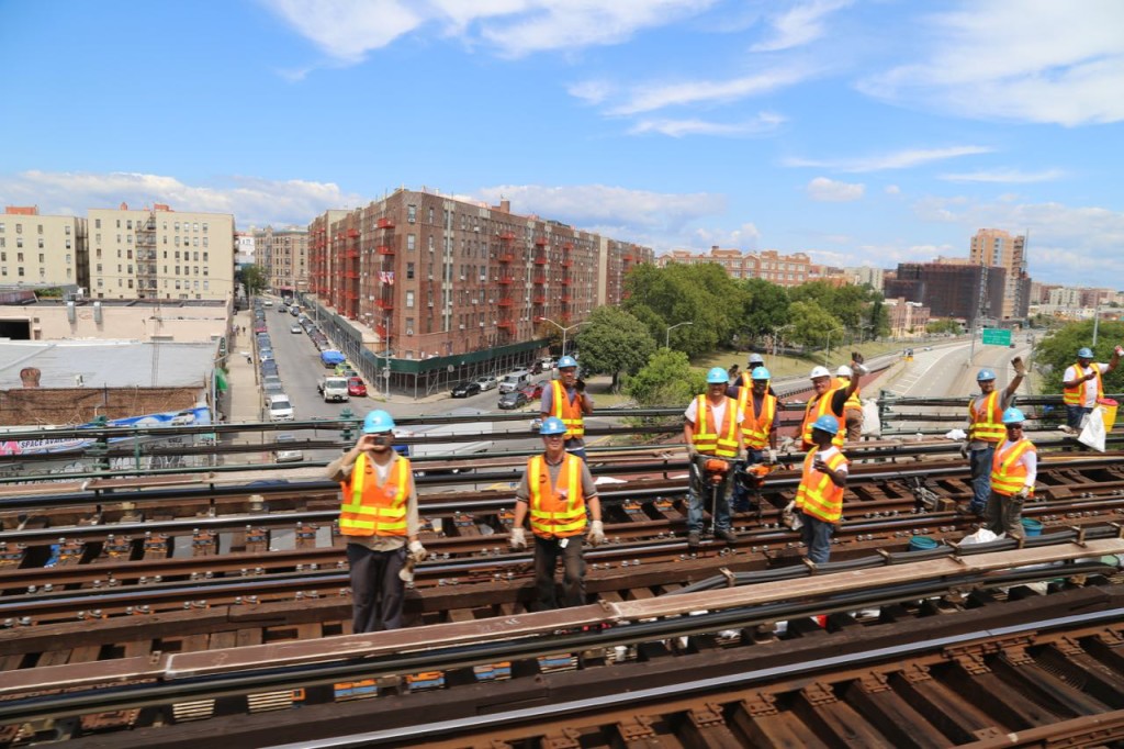 rail workers taking photos as we pass by