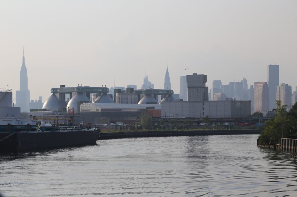 Manhattan skyline behind Newtown Creek Wastewater Treatment Plant