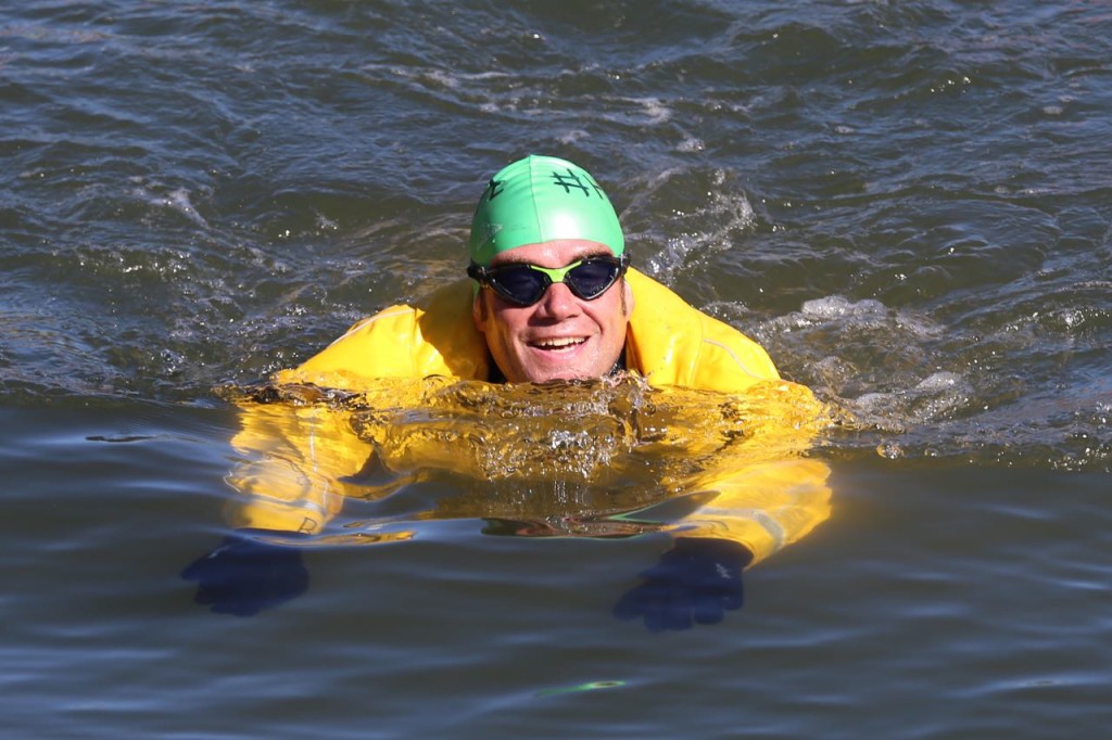 Christopher Swain swimming the Gowanus Canal in a dry suit.