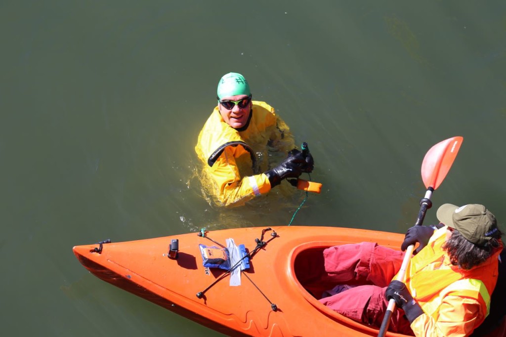 He takes measurements of the water.