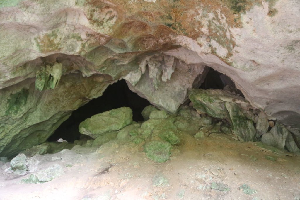 Entrance to Cave 2, at very lower left side of dark cave area, opening on other side of cave is visible