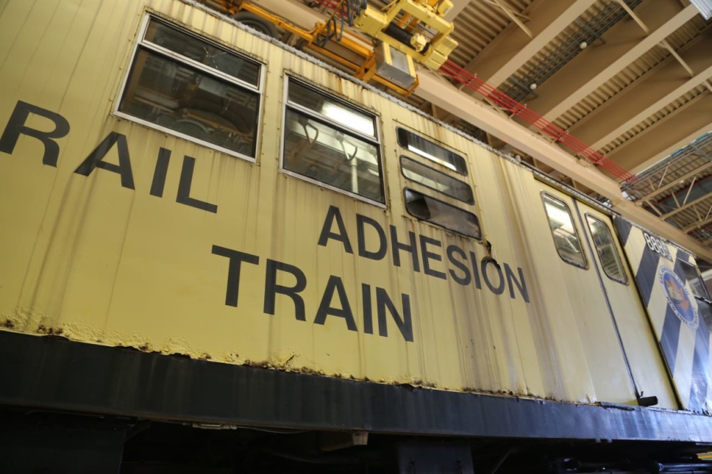 An old rail car that was converted to a rail adhesion train, used to add sand or a coating when leaves start to coat the rails. It is no longer, or rarely used, as contractors are hired to clear the rails of leaves.