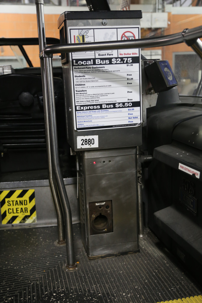 The outlet at the bottom of the fare box is where a hose is inserted to vacuum out the money. They vacuum the money to a secure box. 