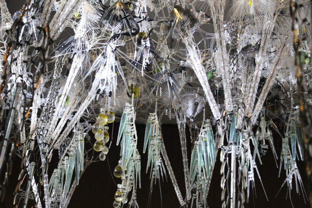 Hanging pieces of science items include flasks, tubes, and pipets