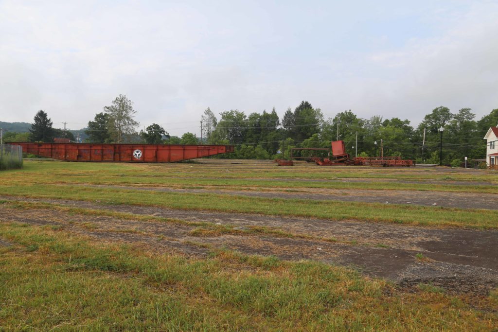 Former roundhouse with alternating concrete and grass in foreground