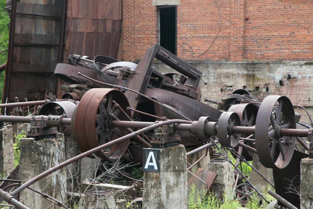 Mechanical rolling parts of the former mill. A metal saw used to cut the wood is in there.