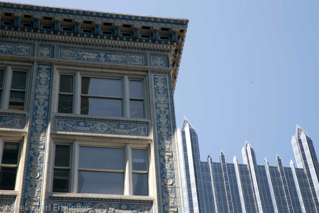 Old tiled building juxtaposed with PPG glass building