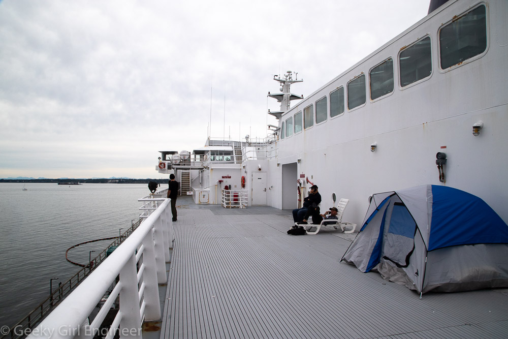 A tent set up on an outside deck of a ship
