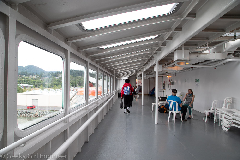 Person walking down an inside passageway on ship